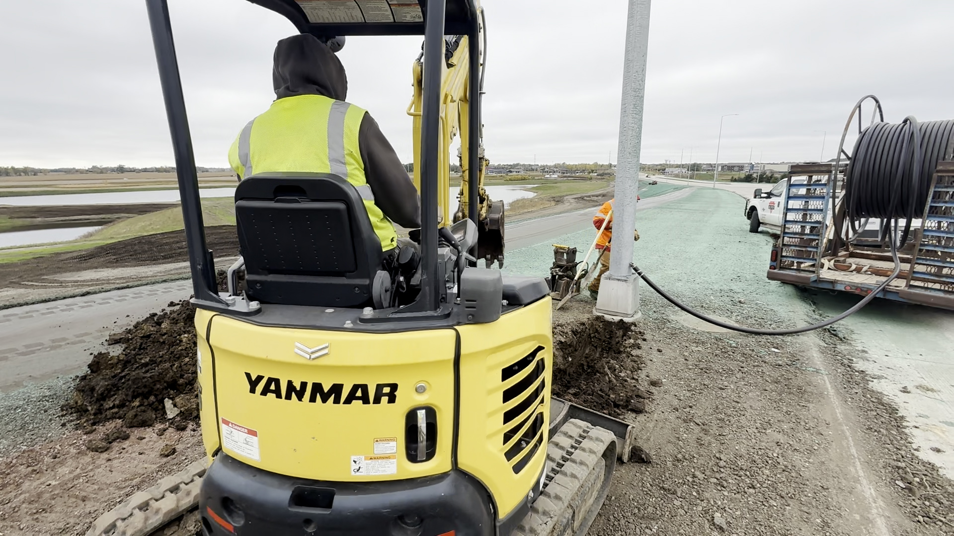 Electrical crews install streetlights along South Veterans Parkway.