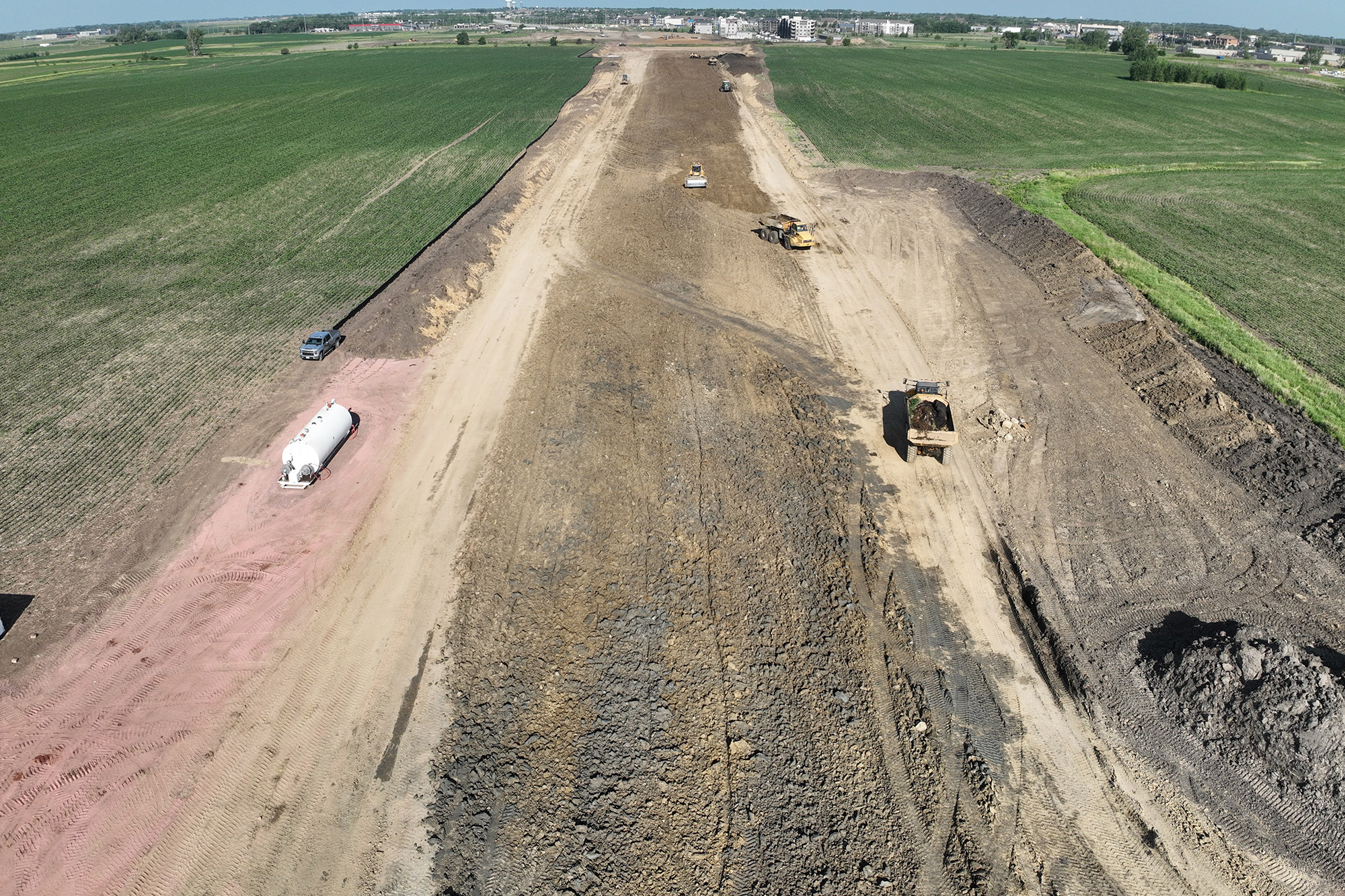 Drone view of graded roadway area.