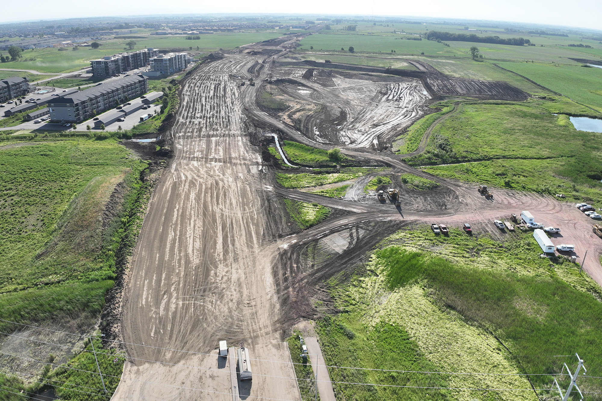 Drone view of graded future roadway area.